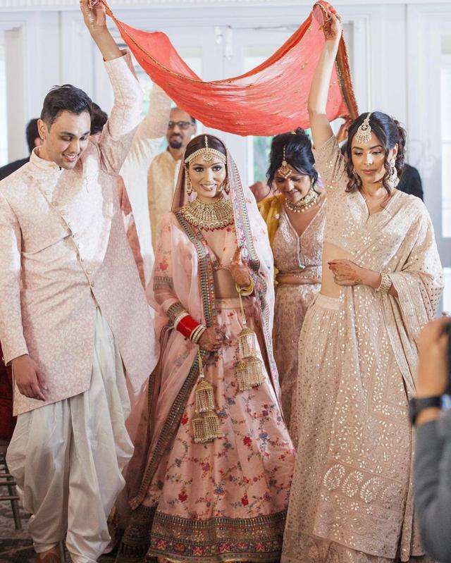 bride walking under mother's odhni