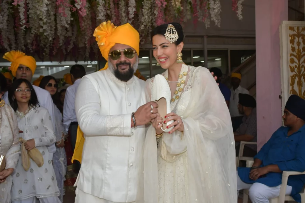 Luv Ranjan and Poppy Jabbal Luv Ranjan and Poppy Jabbal carrying out the Joota Chppai ceremony.